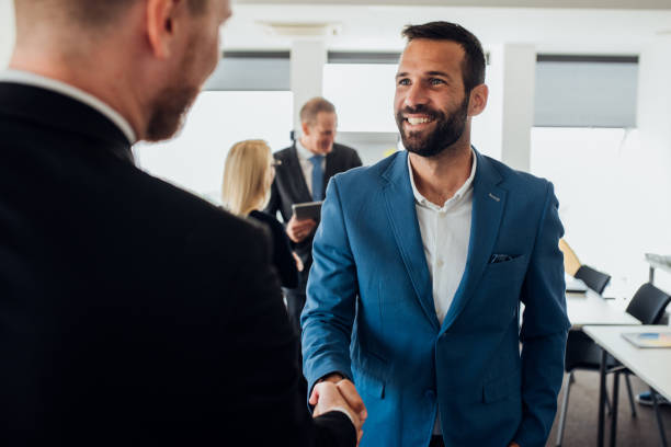 istock Businessman shaking hands with coworker 1064936198