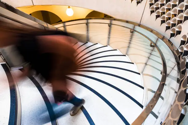 Photo of Motion Blur of Speeding Person on Abstract Spiral Staircase