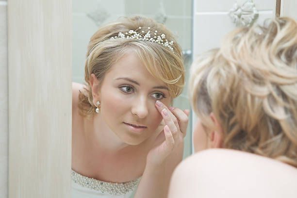 Beautiful bride looking in mirror stock photo