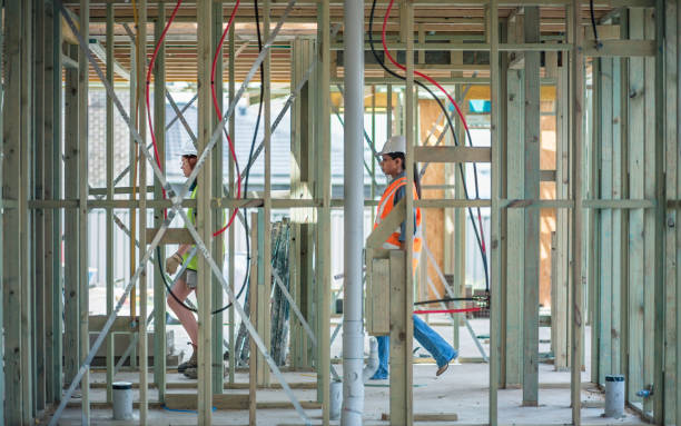 istock Two women working on construction site, walking through wood frames 1064953484