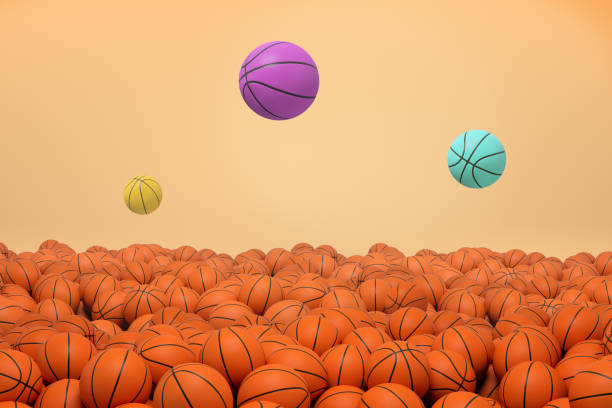istock 3d rendering of three differently colored basketball balls flying and jumping over an endless field of identical orange balls. 1064958082