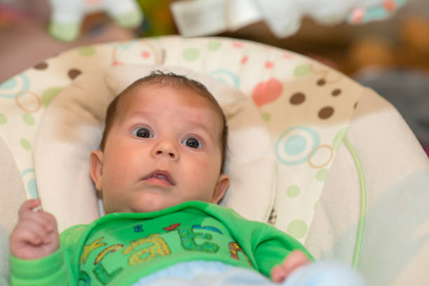 istock The newborn lies on swing automatic electrical chair and enjoys it 1064961798