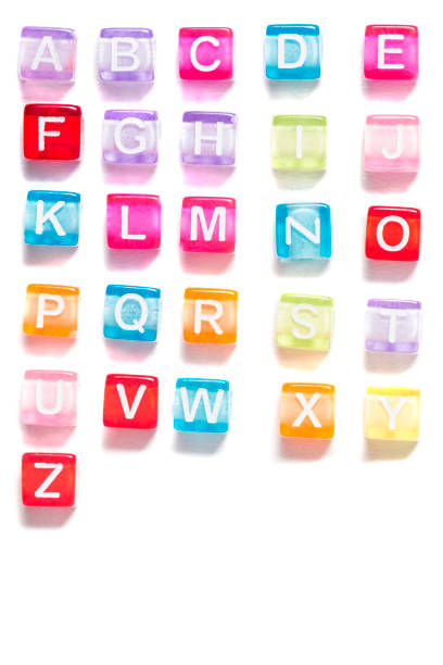 Colorful plastic beads with letters Colorful plastic beads alphabet isolated on a white background. bead stock pictures, royalty-free photos & images