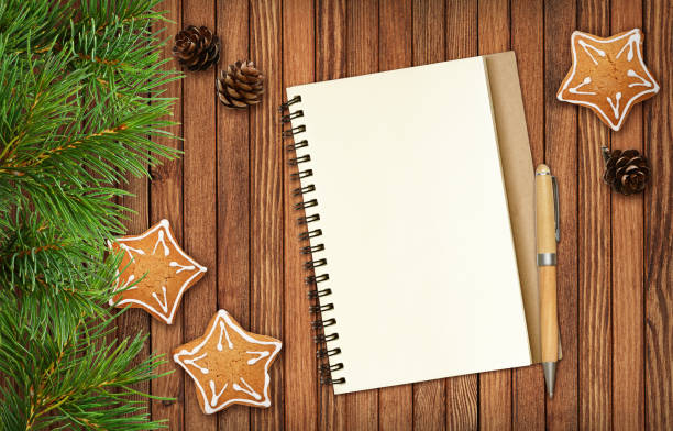 istock Notepad and a pencil with Christmas decorations and cookies 1064965418