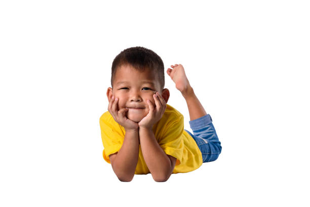 happy asian children lying on floor isolated white background with clipping path