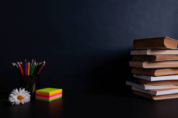 istock flower with books on your desktop 1064970450