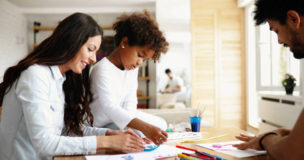 istock Mother and father drawing together with their child 1064970872
