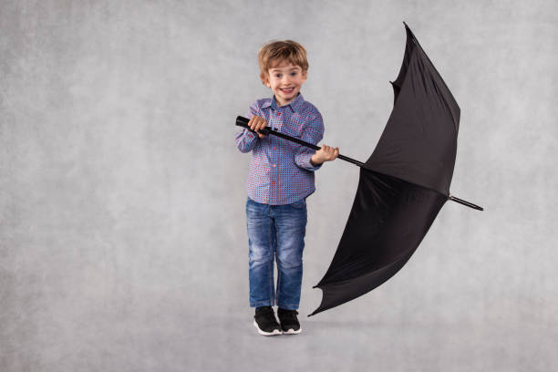 istock small businessman holding an umbrella in hands 1064972230