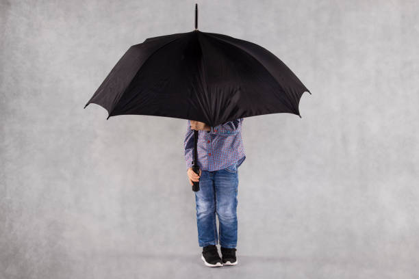 istock young insurance agent, full protection under the umbrella 1064972290