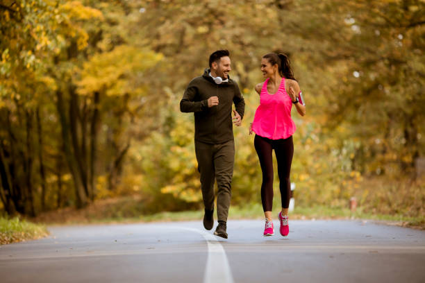 istock Young people jogging and exercising in nature 1064973546