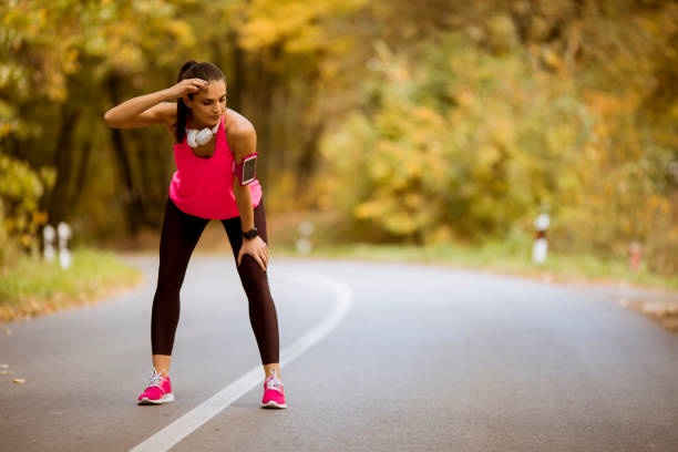 istock Young woman have a break during training in the autumn forest 1064973626