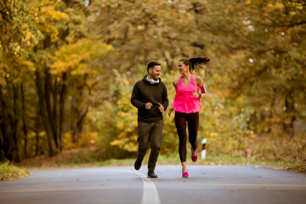 istock Young people jogging and exercising in nature 1064973644