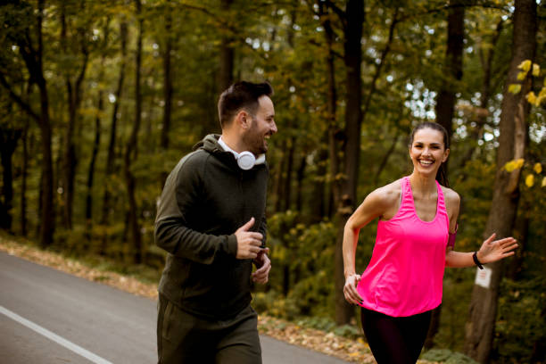 istock Young people jogging and exercising in nature 1064973674
