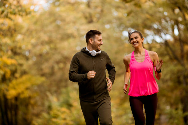 istock Young people jogging and exercising in nature 1064981112