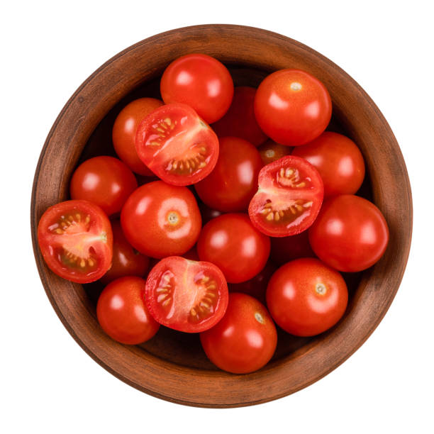 istock Fresh tomatoes on plate. Isolated on white background. Top view. 1064981484