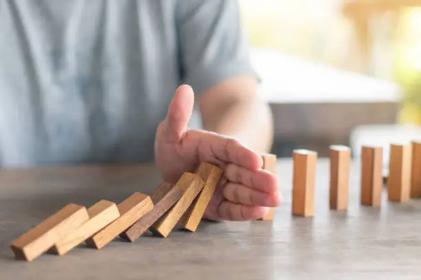 Photo of Businessmen use their hands to break the bar. Continuous falling. Hedging concept Preventing mistakes in business, losing money to retain benefits or haunting.