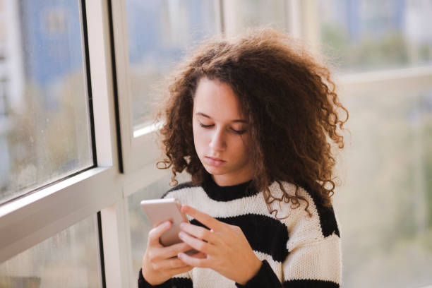 istock Teenage girl using mobile phone 1064982946