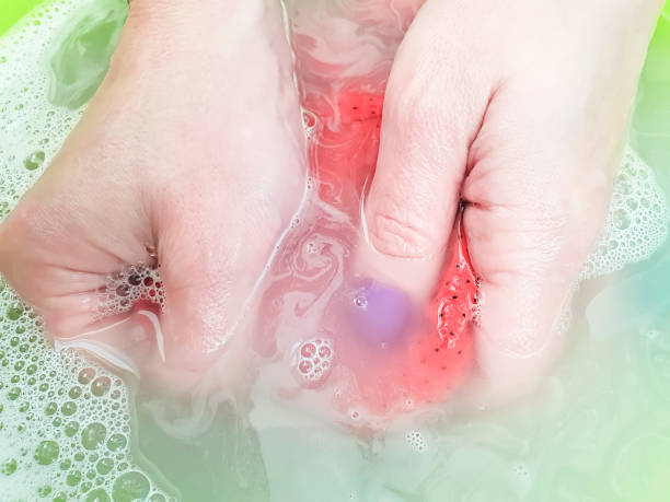 istock female hands washing clothes closeup 1064984716