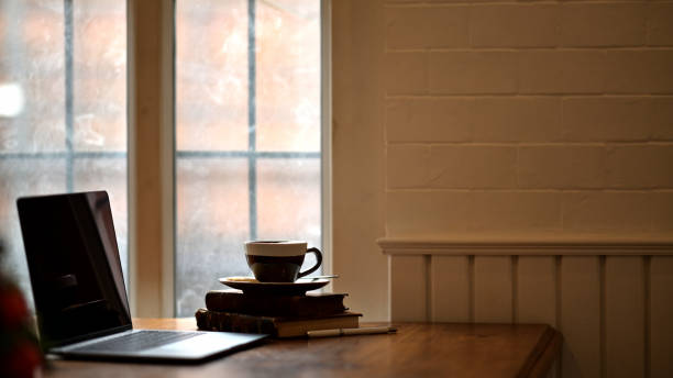 istock Laptop with coffee on wooden desk and copy space. 1064990422