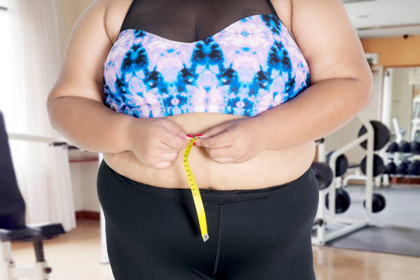istock Unknown  woman measuring her waistline 1064990440