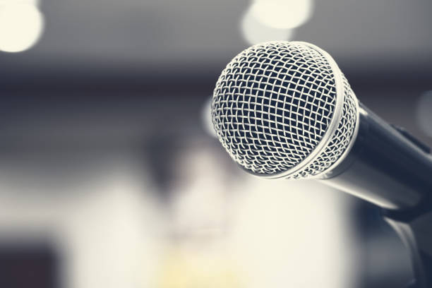 istock Microphones singing on stage in black colour 1064990998
