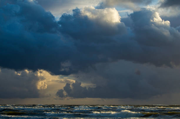 istock Beautiful evening clouds over the storming Bali Sea. 1064994760
