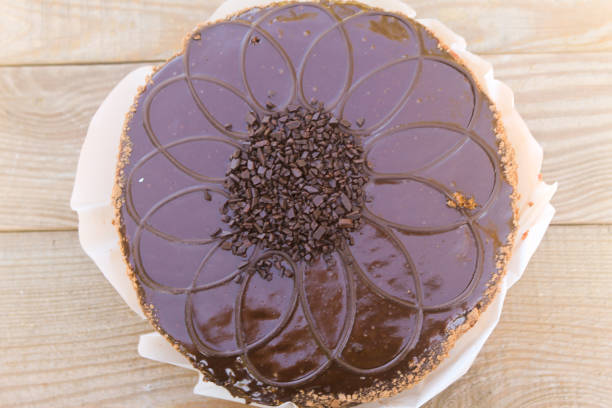 istock Big chocolate cake on wooden table. Top view 1064994862