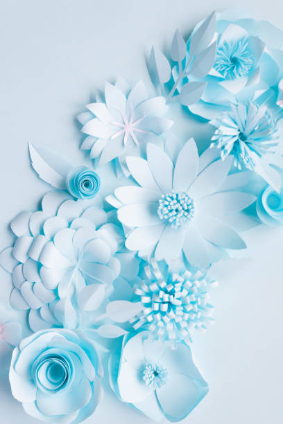 istock blue paper flowers on the blue background 1064997724