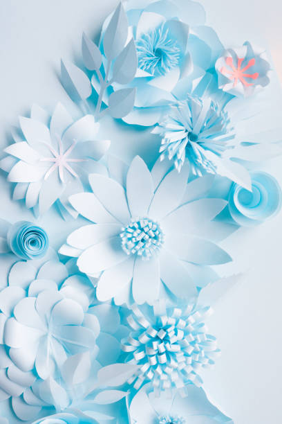 istock blue paper flowers on the blue background 1064997726