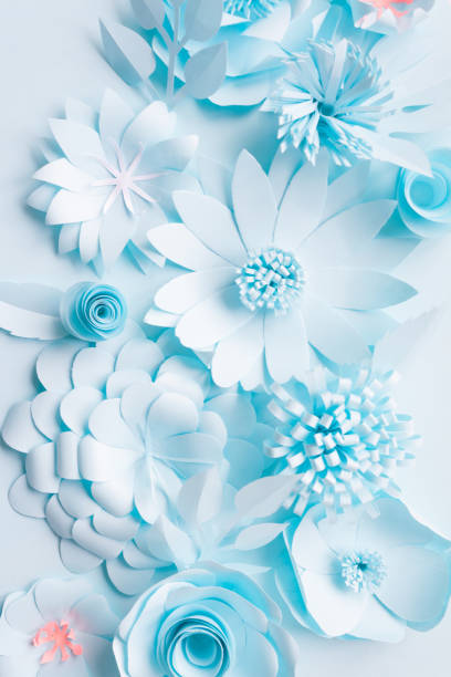 istock blue paper flowers on the blue background 1064997732