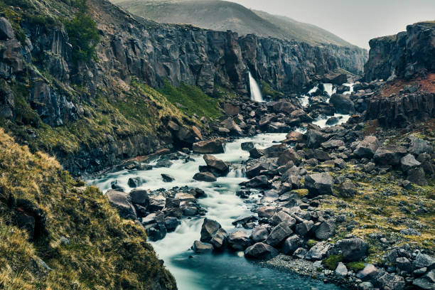 Mountain waterfall on summer. Cloudy day