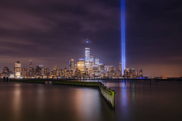 istock Tribute in Light in NYC from Jersey City waterfront walkway 1065005862