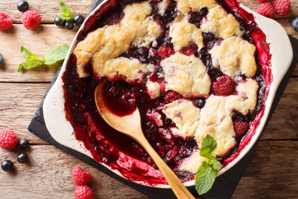 istock Berry cobbler with currants, raspberries and blueberries decorated with mint close up.  Horizontal top view 1065013270