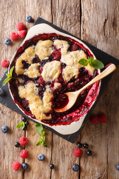 istock English cuisine: berry cobbler is decorated with mint closeup.  vertical top view 1065013356