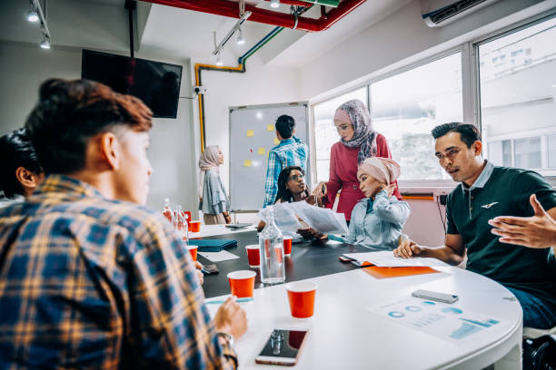 istock Developing new ideas and networking in multi-ethnic group of business people 1065013896