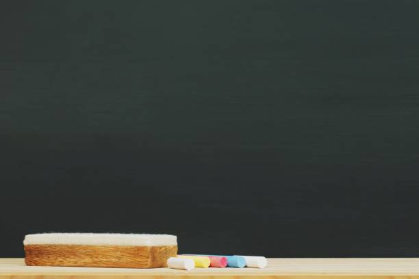 istock Blank Dark blackboard with color Chalk and eraser on the frame for drawing in Classroom. Horizontal composition. copy space empty Chalkboard Background. back to school. 1065015970