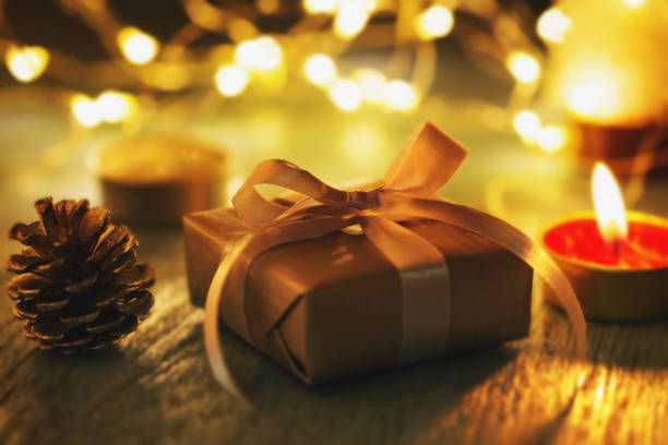 istock Christmas present on dark background with candle light 1065038502
