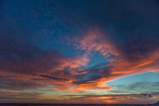 istock Dramatic colored sky at sunset. Moon and star in the clouds. 1065043198