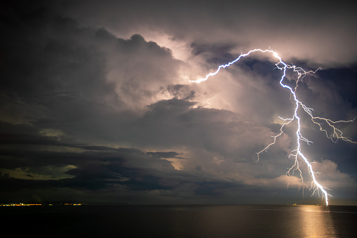 Lightning above the sea. Sea at night