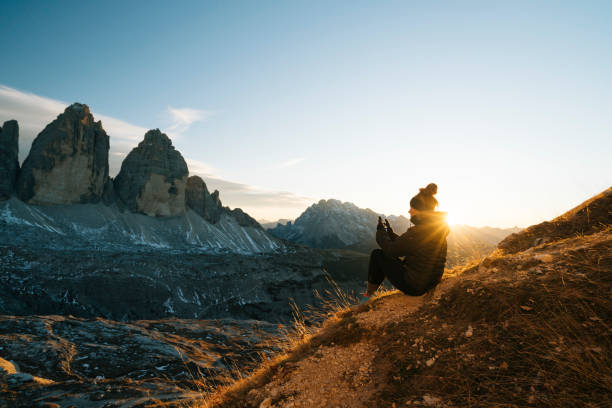 istock Female hiker looks at view at sunset 1065043784