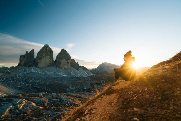istock Female hiker looks at view at sunset 1065043846
