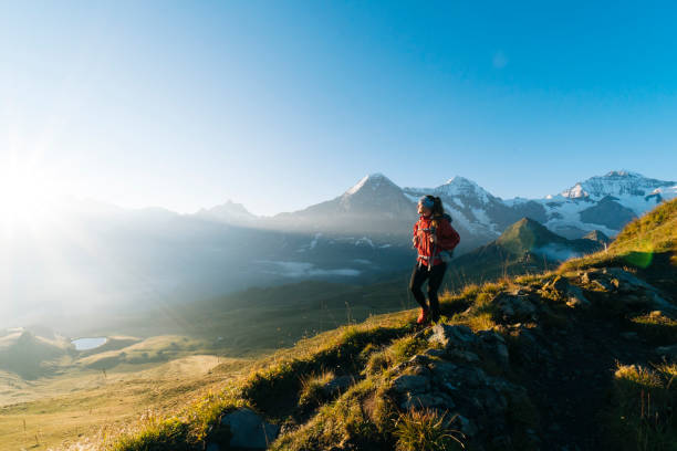 istock One young female hiker walks up hill 1065044034