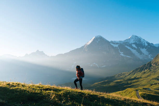 istock One young female hiker walks up hill 1065044064