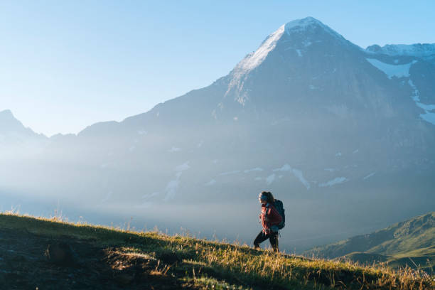 istock One young female hiker walks up hill 1065044068