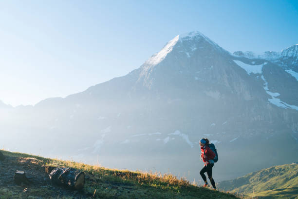 istock One young female hiker walks up hill 1065044074