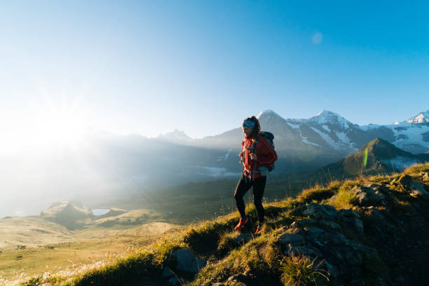 One young female hiker walks up hill