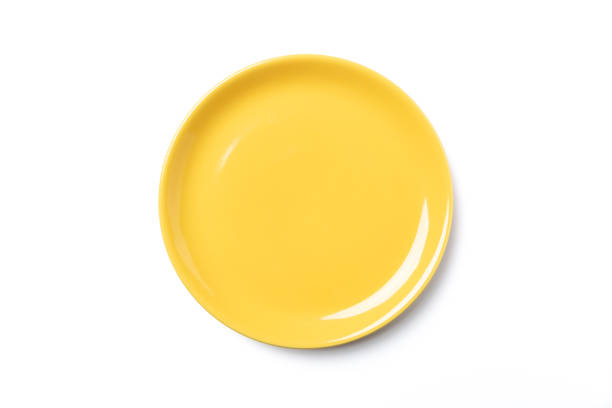 istock Pastel yellow plate isolated on white background 1065044192