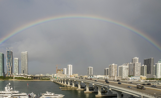 Miami, Florida. Rainbow after a tropical rainfall over Miami and  McArthur Causeway, the bridge that connects Miami to Miami Beach.