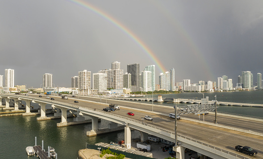 Miami, Florida. Rainbow after a tropical rainfall over Miami and  McArthur Causeway, the bridge that connects Miami to Miami Beach.