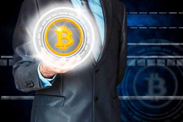 istock Businessman holding a virtual bitcoin. 1065050572